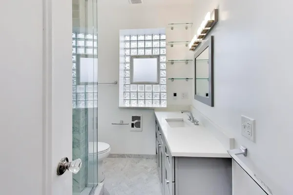 a bathroom with a shower and a sink