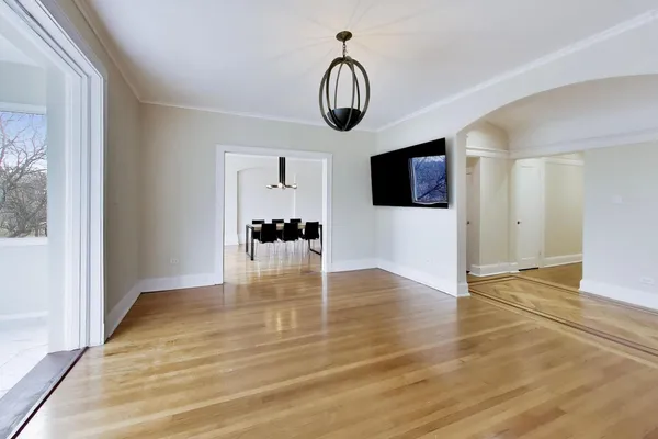 a view of empty room with wooden floor and window