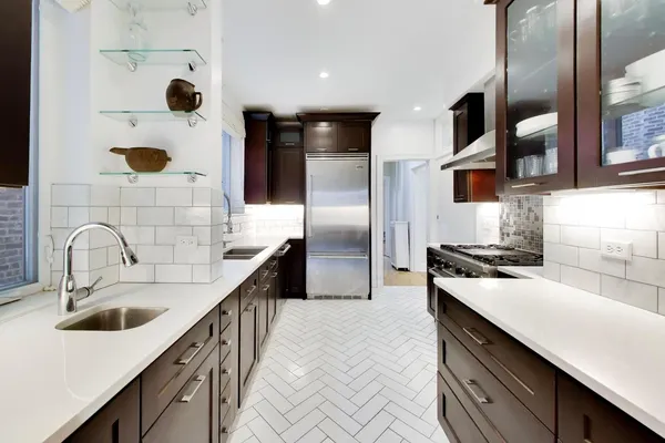 a kitchen with stainless steel appliances granite countertop a stove and a refrigerator