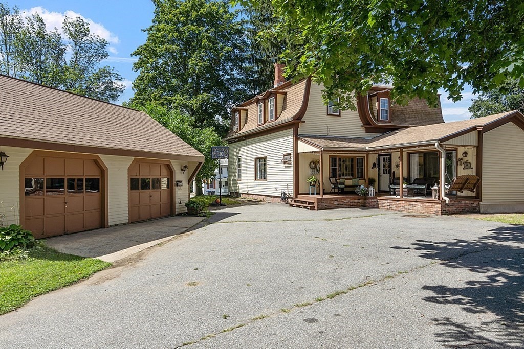 a front view of a house with a yard and potted plants