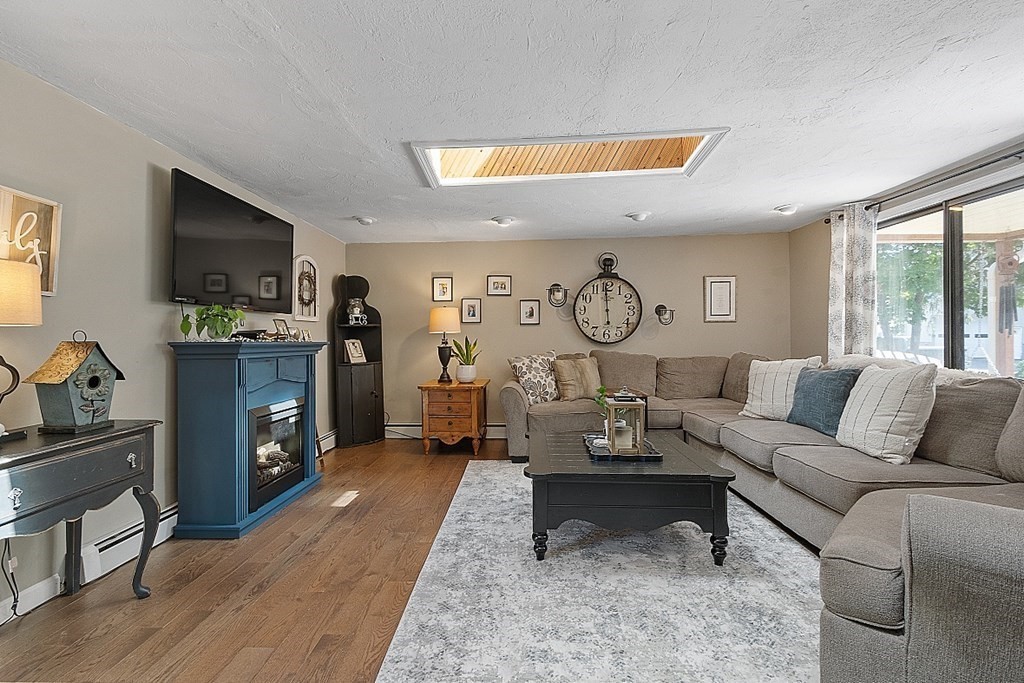 32 Ash Street Winchendon, MA 01475 - Photo 17 of 42 a living room with furniture a fireplace and a flat screen tv