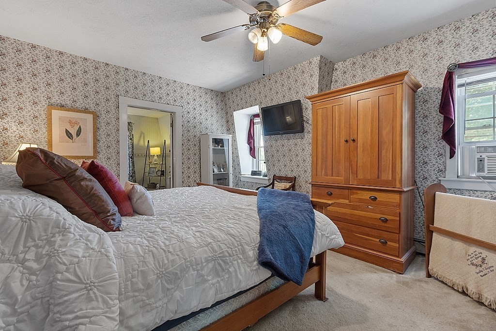 32 Ash Street Winchendon, MA 01475 - Photo 20 of 42 a bedroom with a bed and a chandelier