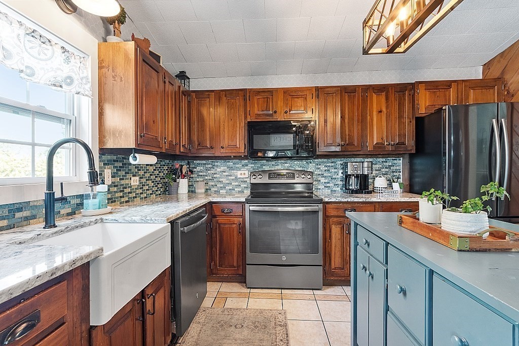 32 Ash Street Winchendon, MA 01475 - Photo 9 of 42 a kitchen with stainless steel appliances granite countertop a sink stove and refrigerator