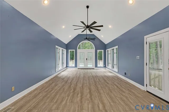 a view of a room with window ceiling fan and wooden floor