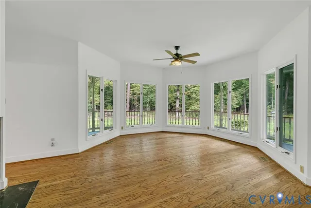 a view of room with window and a ceiling fan