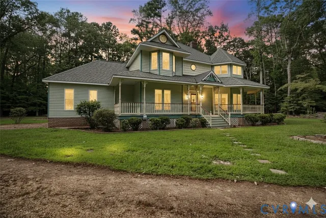 a front view of a house with a garden and yard