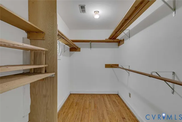 a view of hallway with stairs and wooden floor