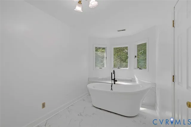 a white bath tub sitting in a bathroom