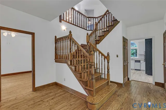 a view of staircase with wooden floor and a rug