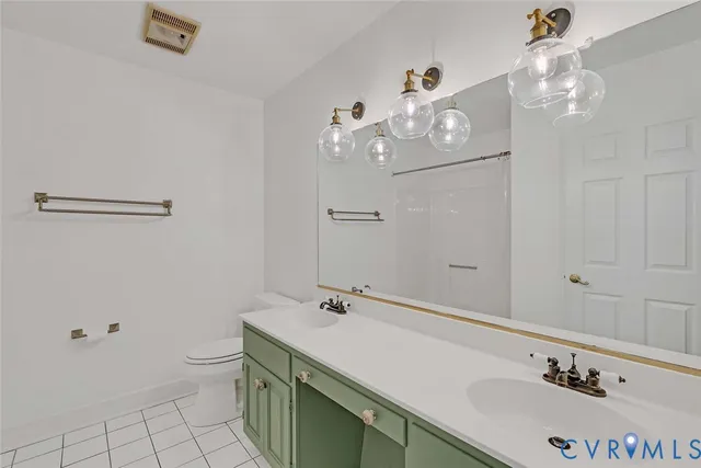 a bathroom with a sink vanity and toilet