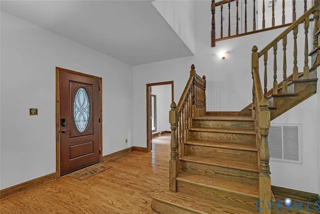 a view of an entryway with wooden floor