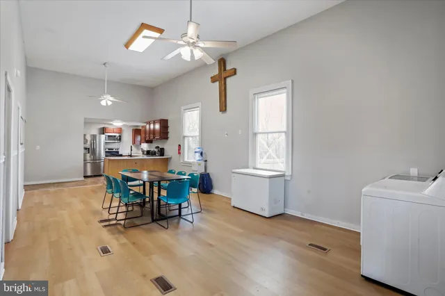 a view of a workspace with furniture and a window