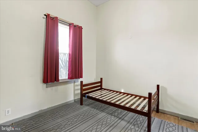 a view of a room with wooden floor and a window