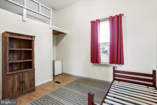 a hallway with a dresser and window