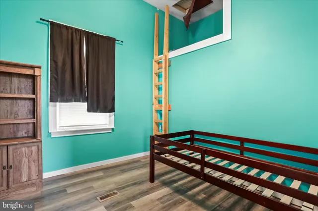 a view of a room with wooden floor and windows