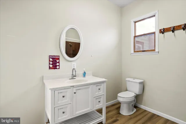 a bathroom with a toilet sink and mirror