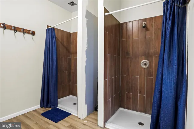 a bathroom with a shower and a mirror