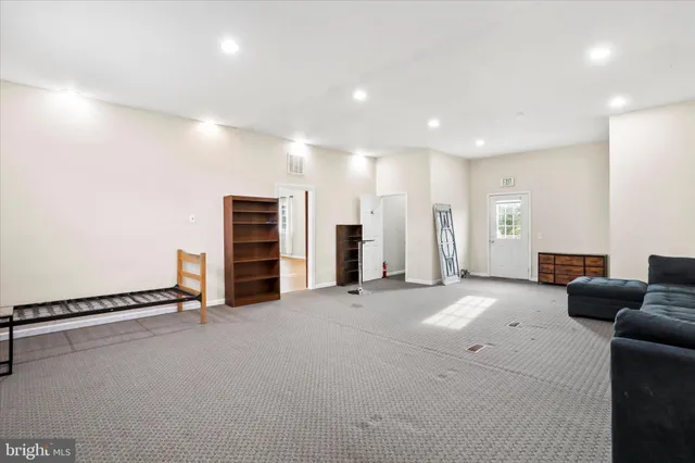 an empty room with furniture and natural light