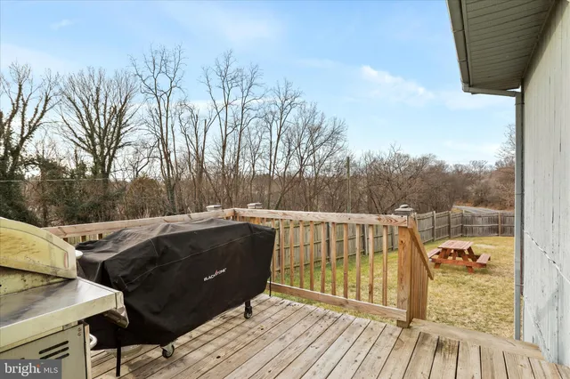 a terrace of a house with wooden floor and outdoor space