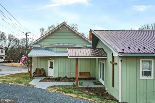 a view of a house with a patio and a yard