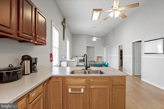 a kitchen with stainless steel appliances granite countertop a sink refrigerator and cabinets