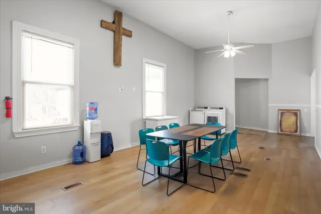 a view of a workspace with furniture and a window