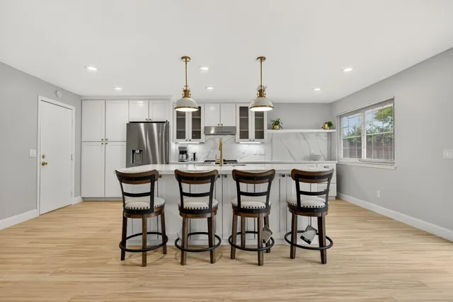 a kitchen with granite countertop a table and chairs
