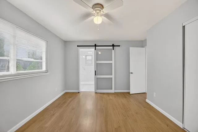 a bathroom with a granite countertop sink a mirror and a bathtub