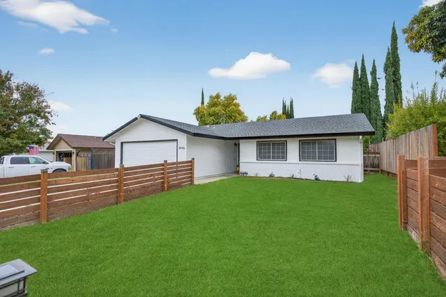 a front view of a house with a garden