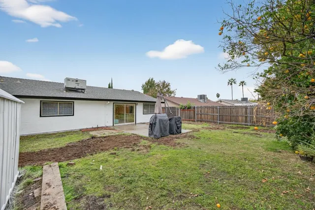 a view of backyard with seating area