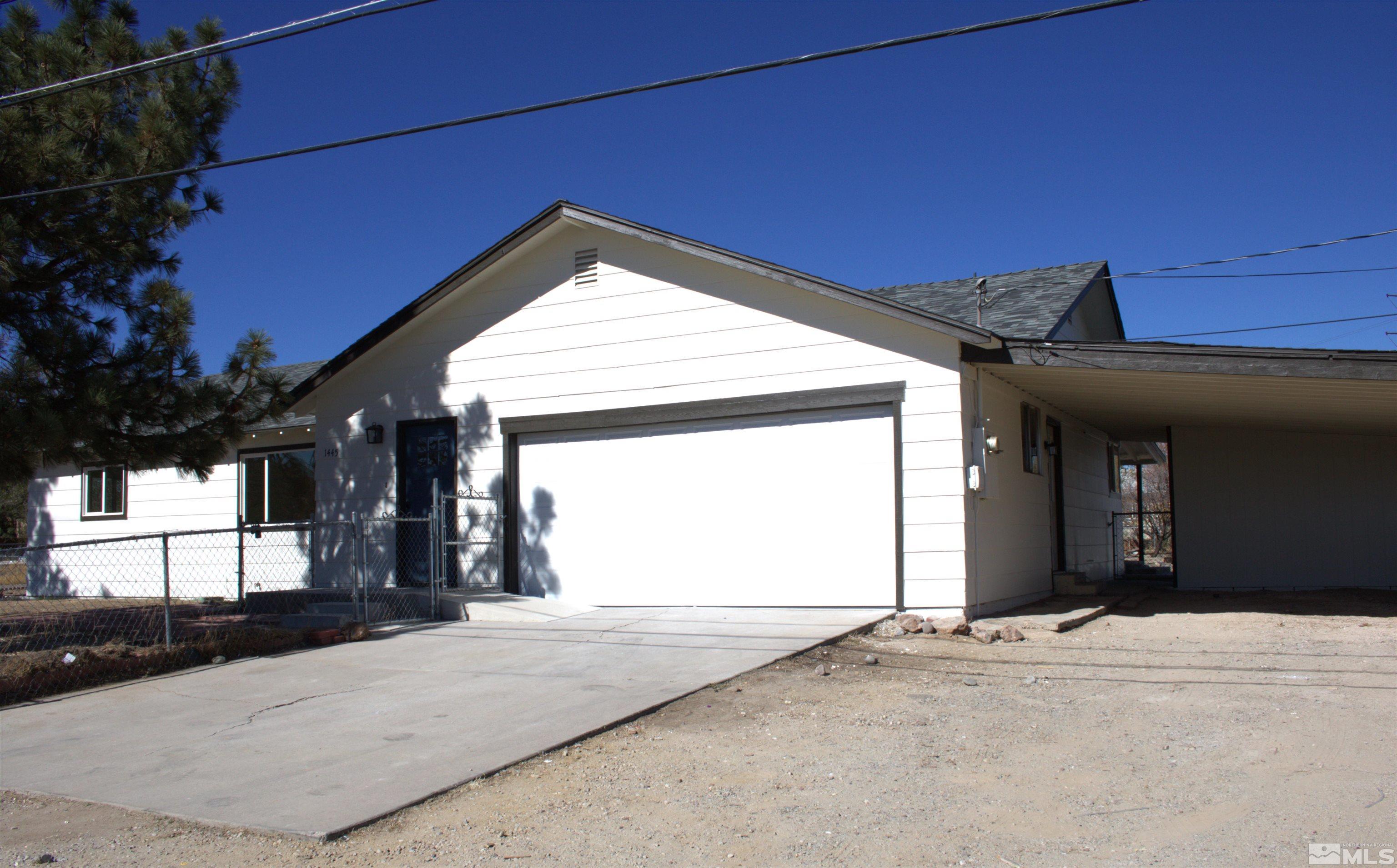 1445 Newcomer Lane Reno, NV 89506 - Photo 1 of 26 a view of a house with a garage