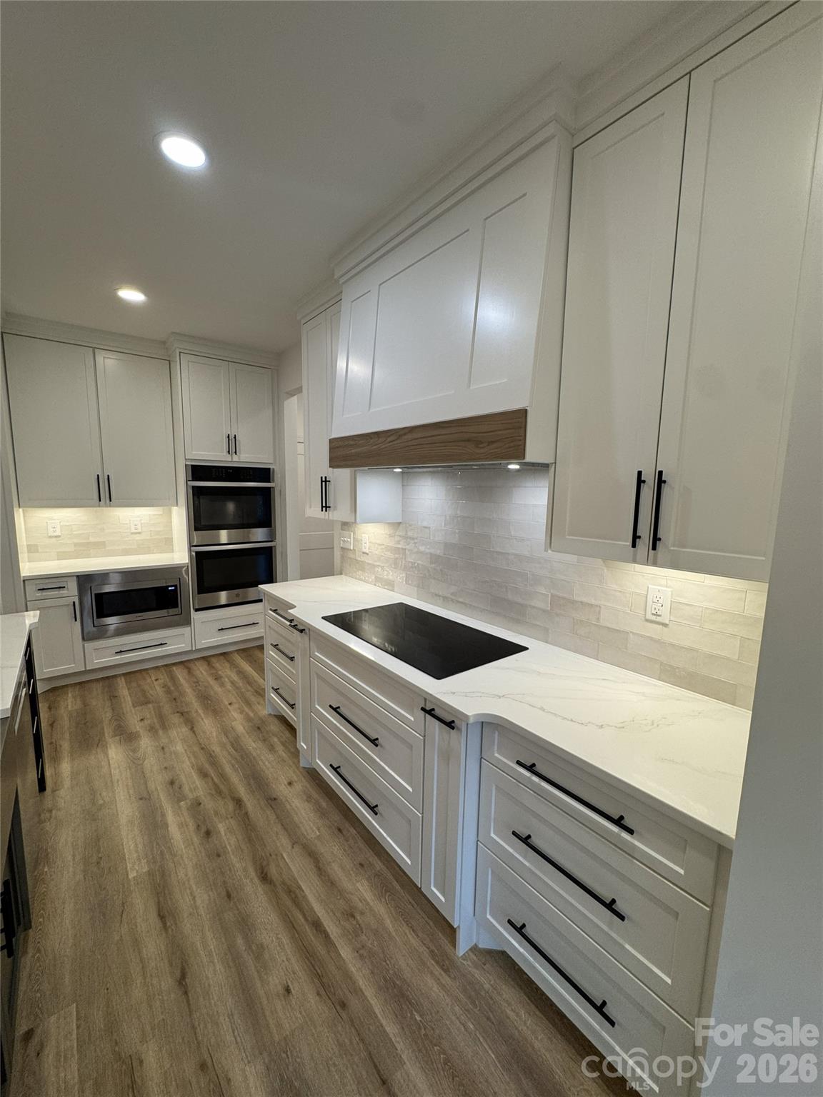 112 Wexford Point, Unit 5 Hickory, NC 28601 - Photo 12 of 47 a kitchen with granite countertop a stove a sink and a refrigerator