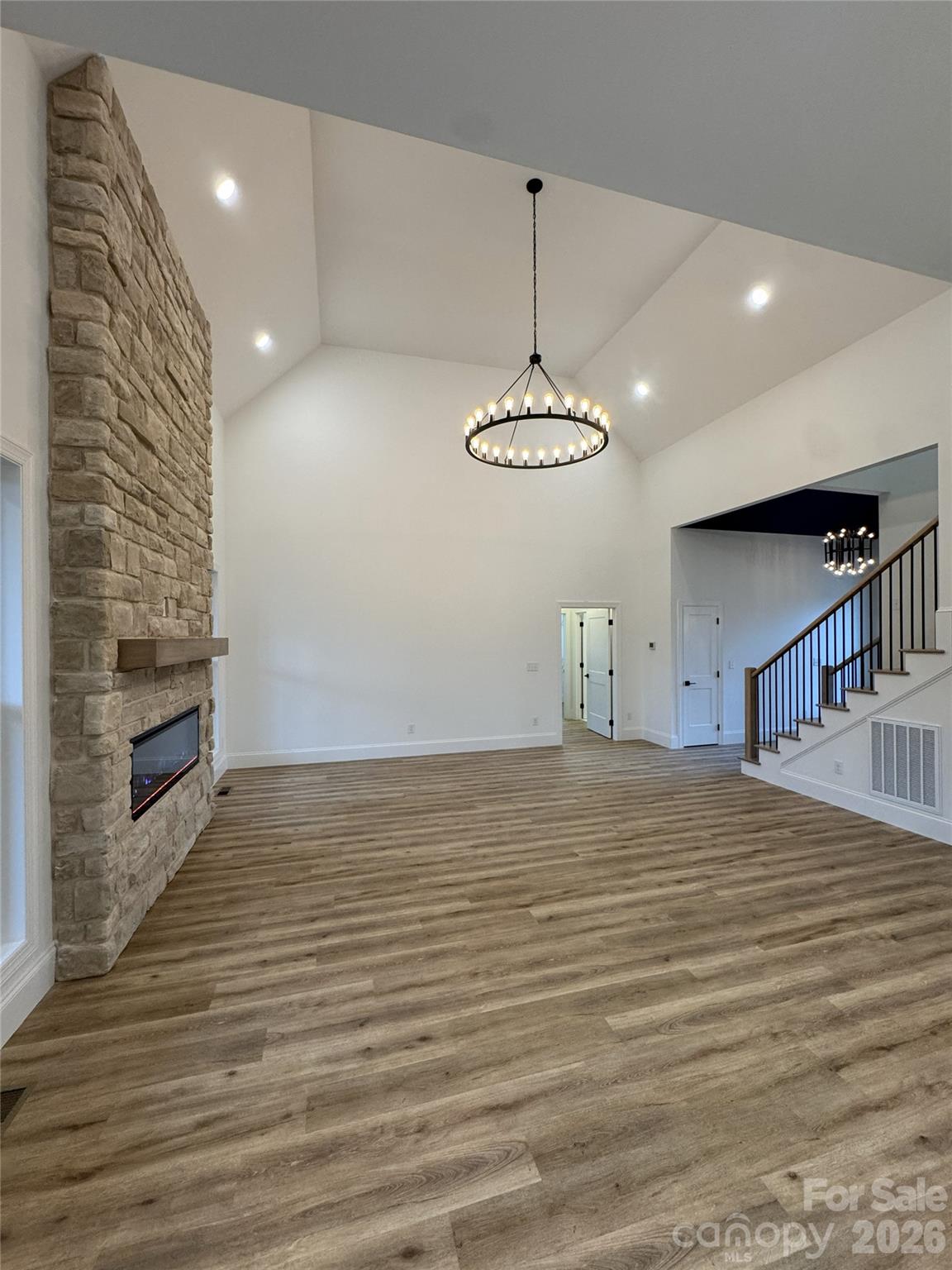 112 Wexford Point, Unit 5 Hickory, NC 28601 - Photo 24 of 47 a view of an empty room with wooden floor and a fireplace