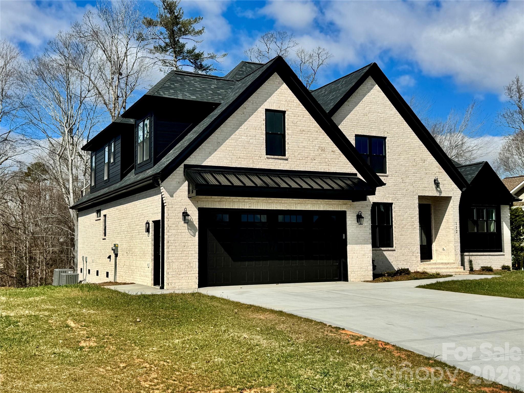 112 Wexford Point, Unit 5 Hickory, NC 28601 - Photo 46 of 47 a front view of a house with a yard and garage