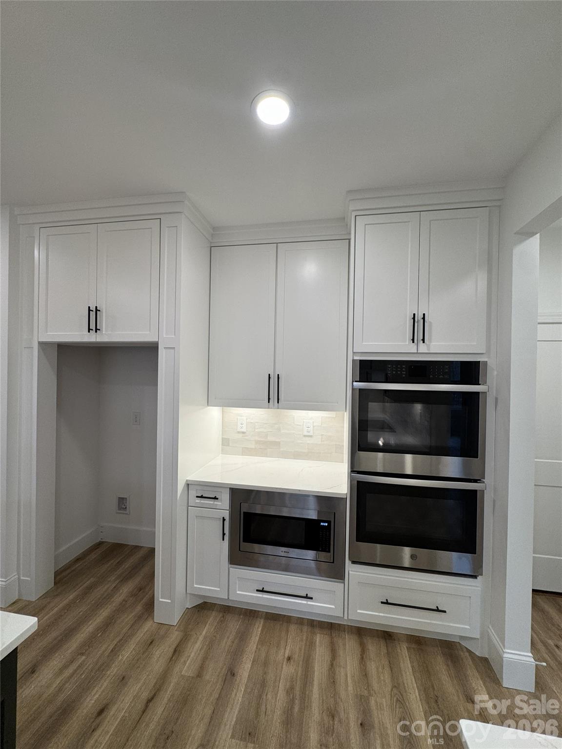 112 Wexford Point, Unit 5 Hickory, NC 28601 - Photo 9 of 47 a kitchen with granite countertop a stove and a fireplace