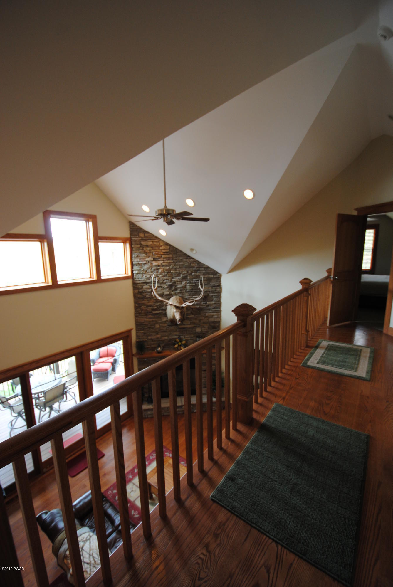 419 Bare Valley Road Montrose, PA 18801 - Photo 50 of 72 a view of staircase with lots of frames on wall and a window