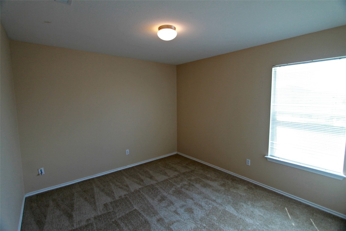 213 Banner Avenue Leander, TX 78641 - Photo 10 of 22 Carpeted empty room featuring baseboards