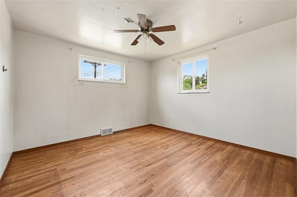 328 Ruthwood Avenue Pittsburgh, PA 15227 - Photo 15 of 32 an empty room with wooden floor and ceiling fan