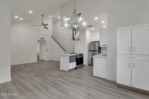 a view of a kitchen with cabinets and stainless steel appliances