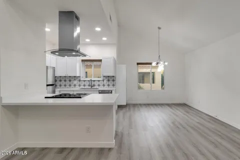 a view of a kitchen with a sink and wooden floor