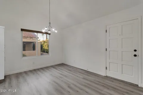 a view of kitchen with wooden floor and electronic appliances