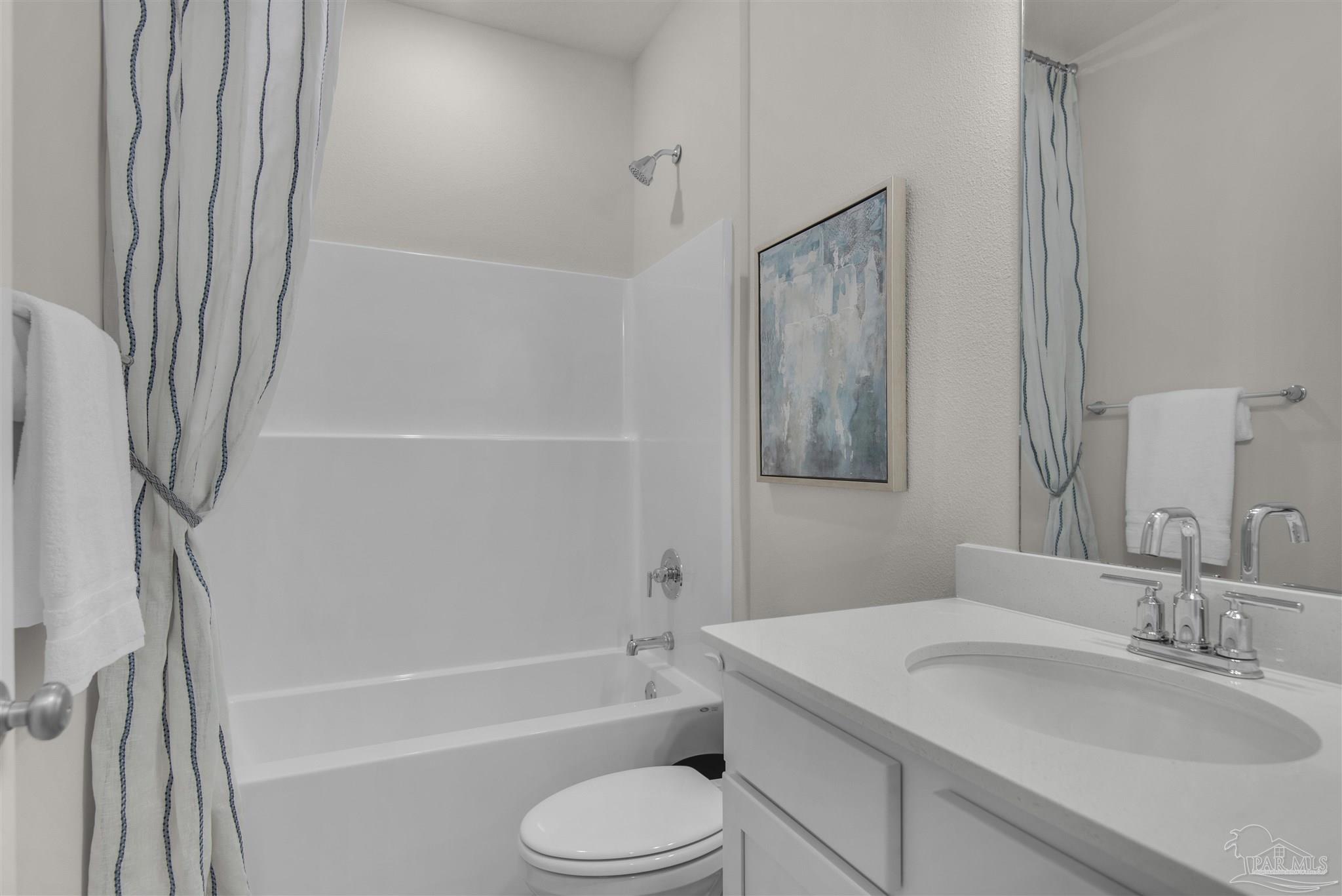 3408 Crossvine Road Cantonment, FL 32533 - Photo 11 of 45 a bathroom with a granite countertop sink toilet and shower