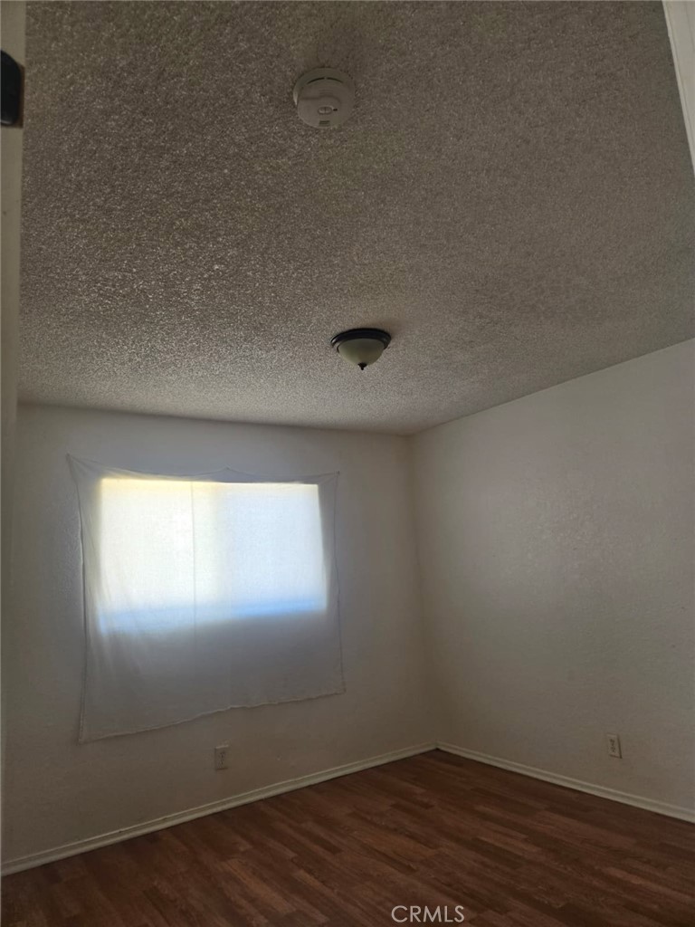 15879 Edwin Street Mojave, CA 93501 - Photo 11 of 12 a view of empty room with wooden floor