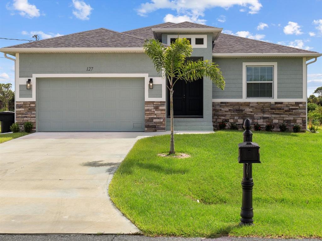 127 Rifle Road Rotonda West, FL 33947 - Photo 1 of 1 a front view of a house with a yard