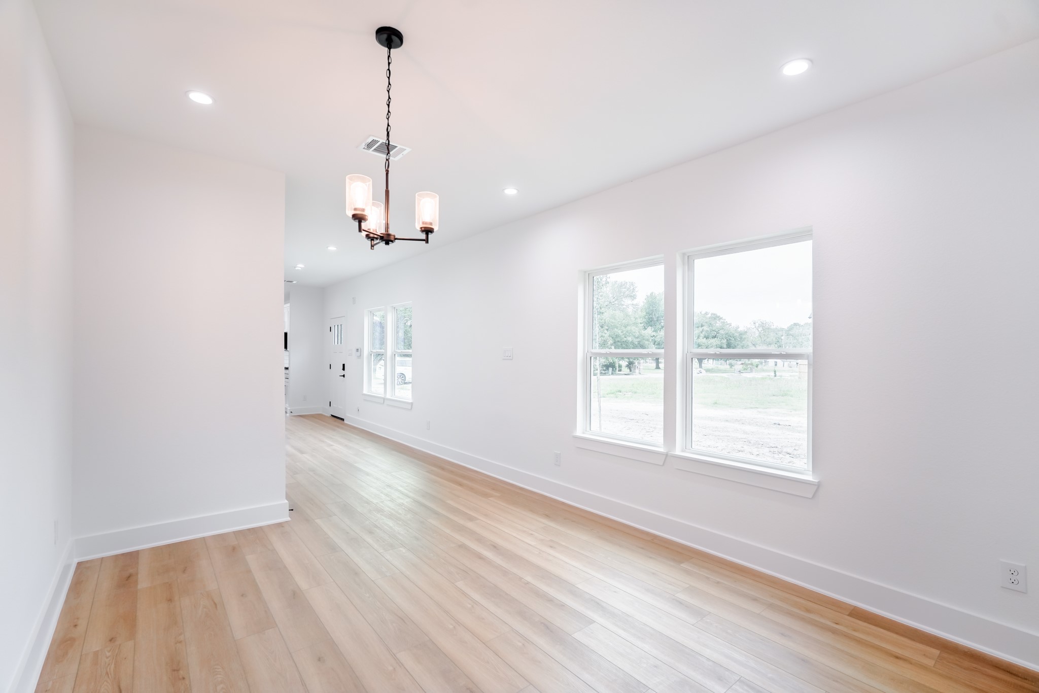 7903 Sunnyhill Street Houston, TX 77088 - Photo 11 of 33 a view of a room with a window and wooden floor