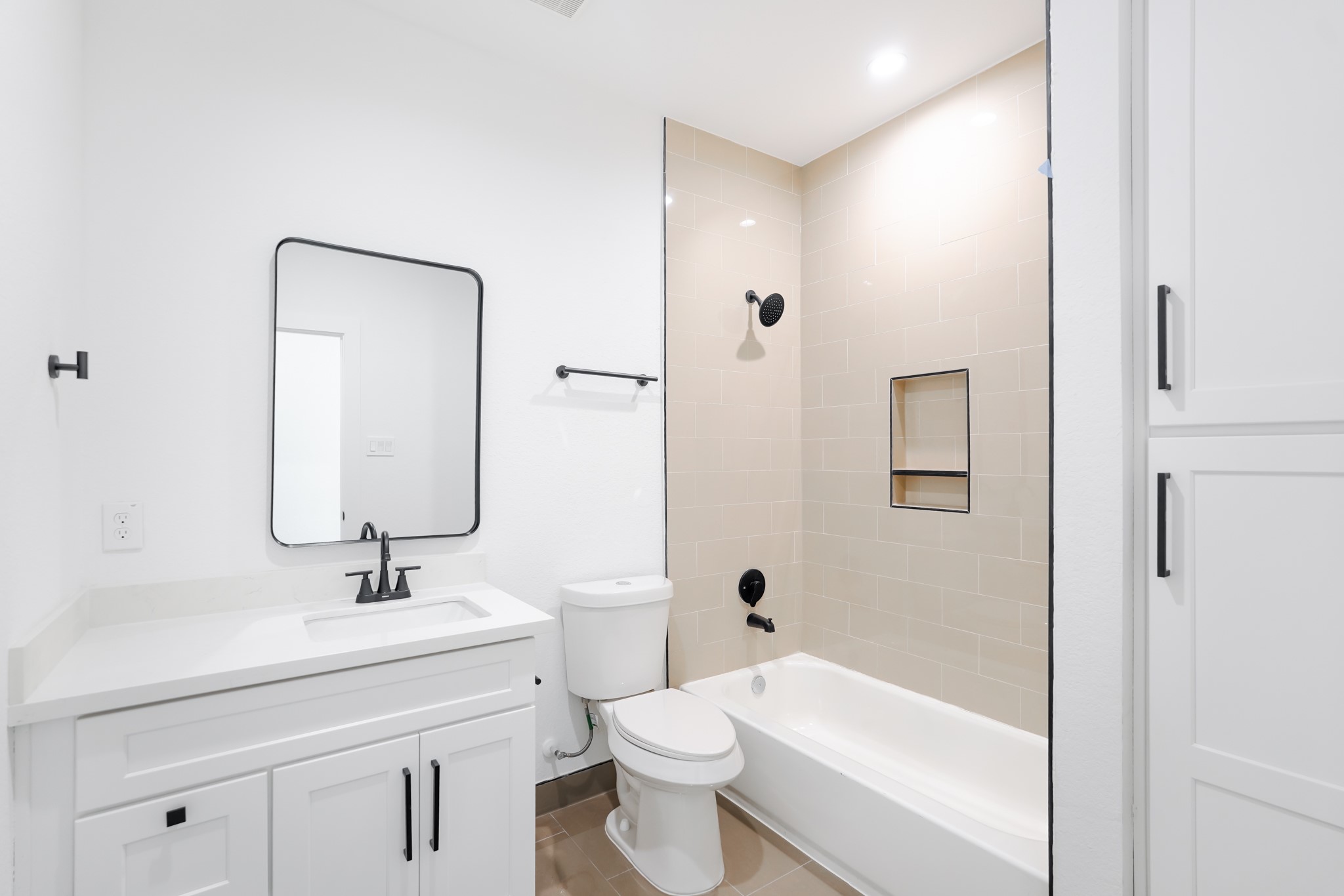 7903 Sunnyhill Street Houston, TX 77088 - Photo 21 of 33 a bathroom with a toilet a sink a mirror and shower