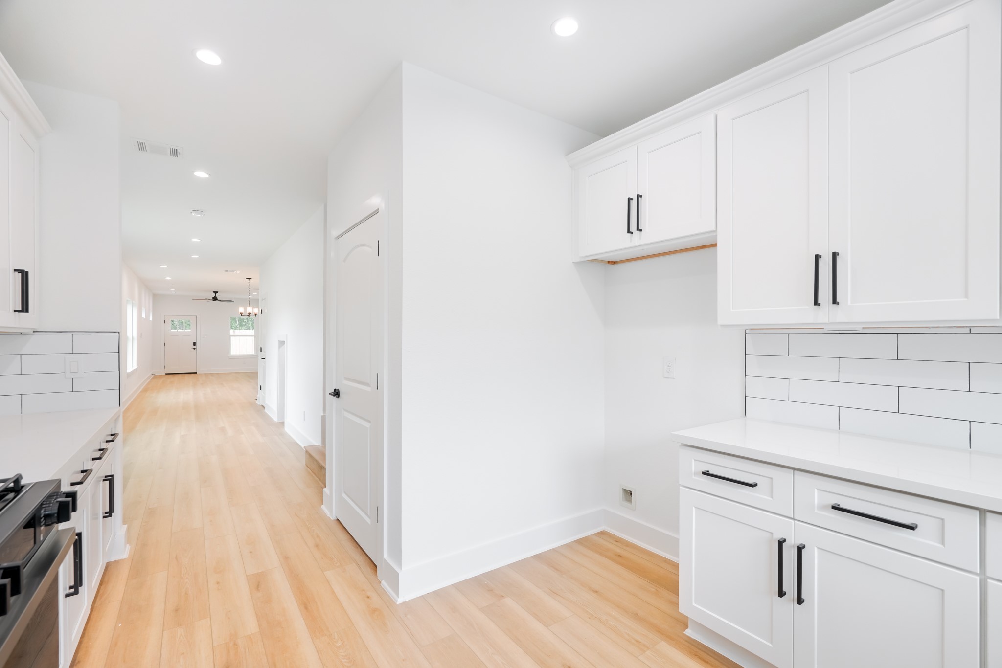 7903 Sunnyhill Street Houston, TX 77088 - Photo 9 of 33 a kitchen with a stove and a wooden floor