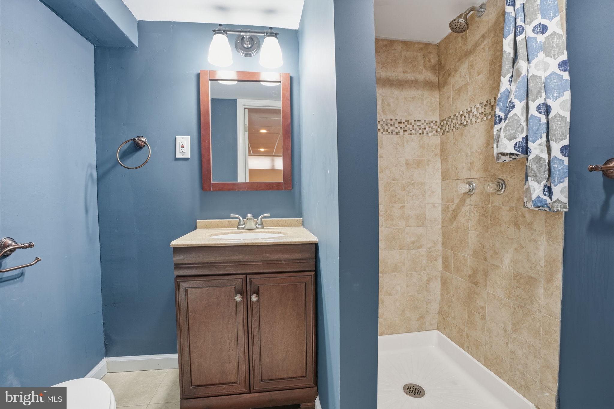 3254 Fordham Road Philadelphia, PA 19114 - Photo 20 of 25 a bathroom with a sink a toilet and shower