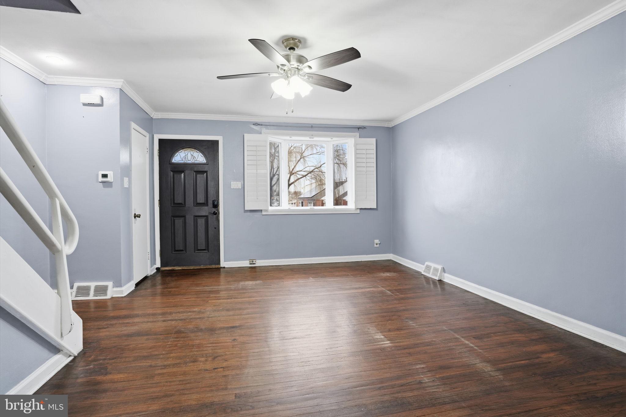 3254 Fordham Road Philadelphia, PA 19114 - Photo 3 of 25 an empty room with wooden floor chandelier fan and windows