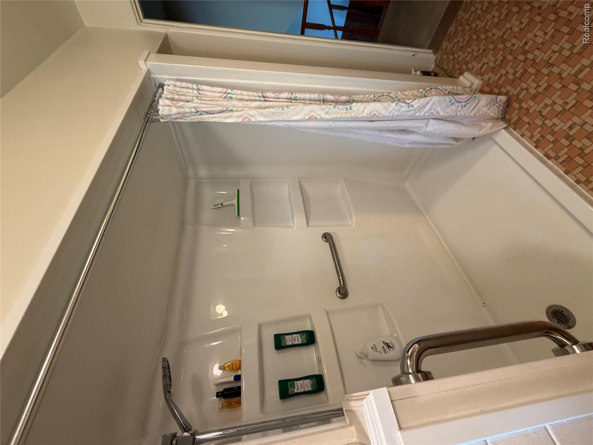8886 East Burnside Road Brown City, MI 48416 - Photo 16 of 22 Walk-in shower with integrated shelving, grab bar, and handheld showerhead